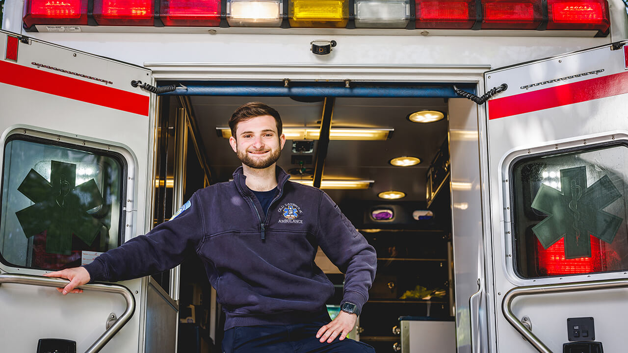 Charles Dunn stands at the back of an ambulance