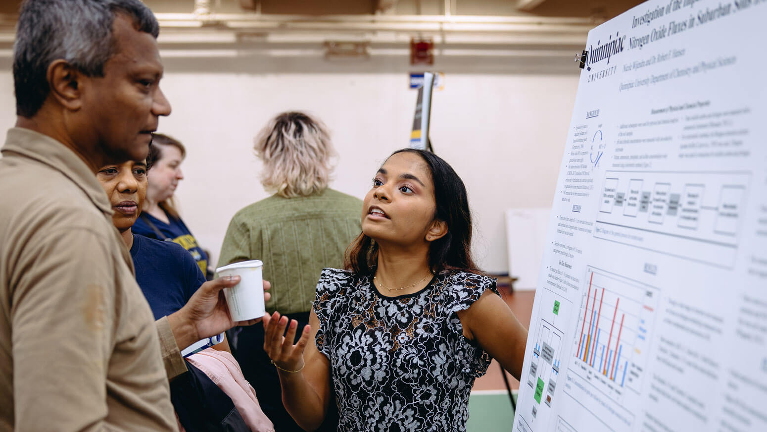 A student presents her project to exploratorium attendees during Bobcat Weekend.